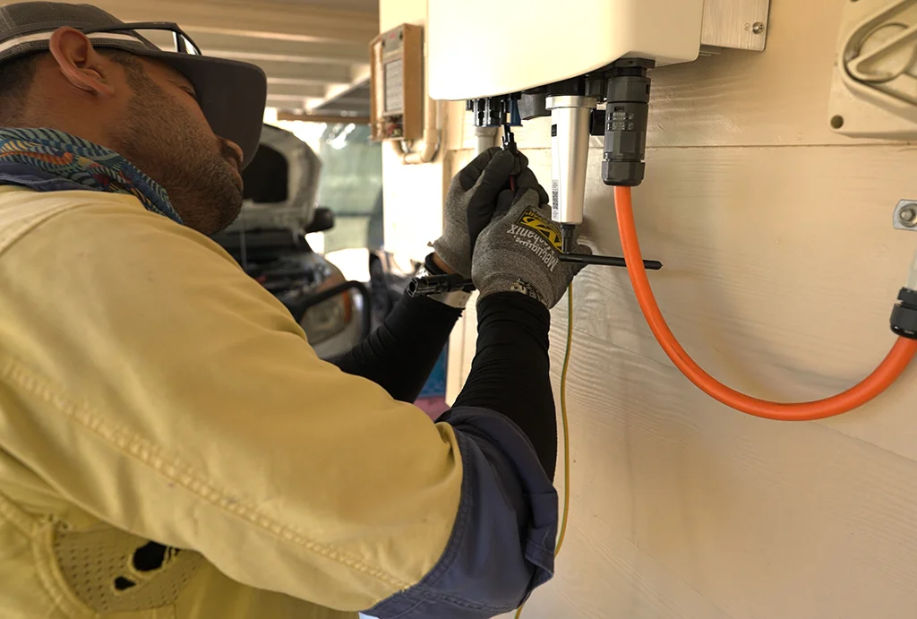 true-north-solar-installer-working-on-inverter