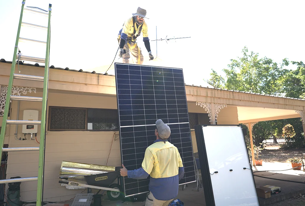 true-north-solar-lifting-solar-panels-to-roof residential solar system